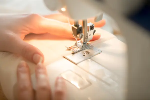 hands sewing machine